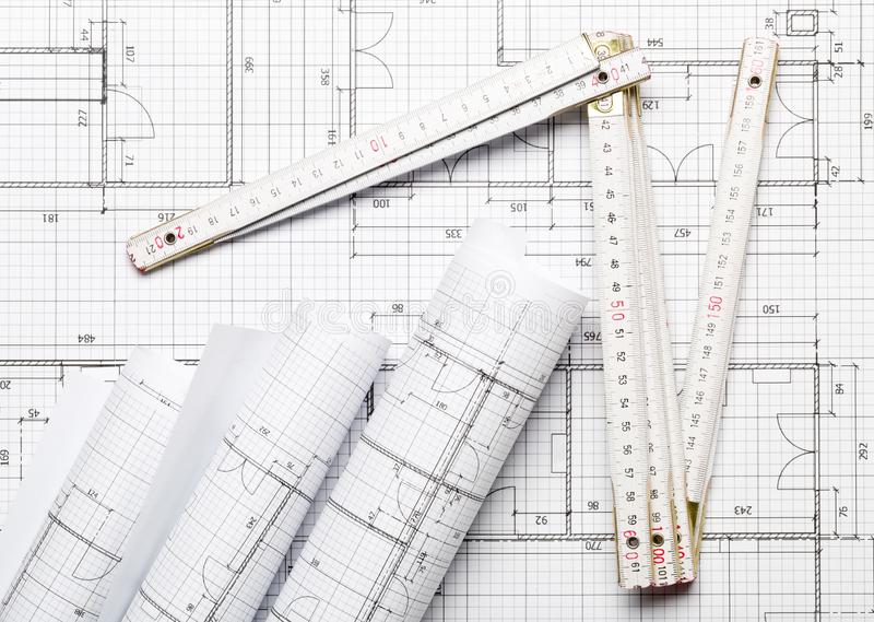 rolls-architectural-blueprint-house-building-plans-background-flat-lay-folding-rule-table-flatlay-top-view-above-144230670